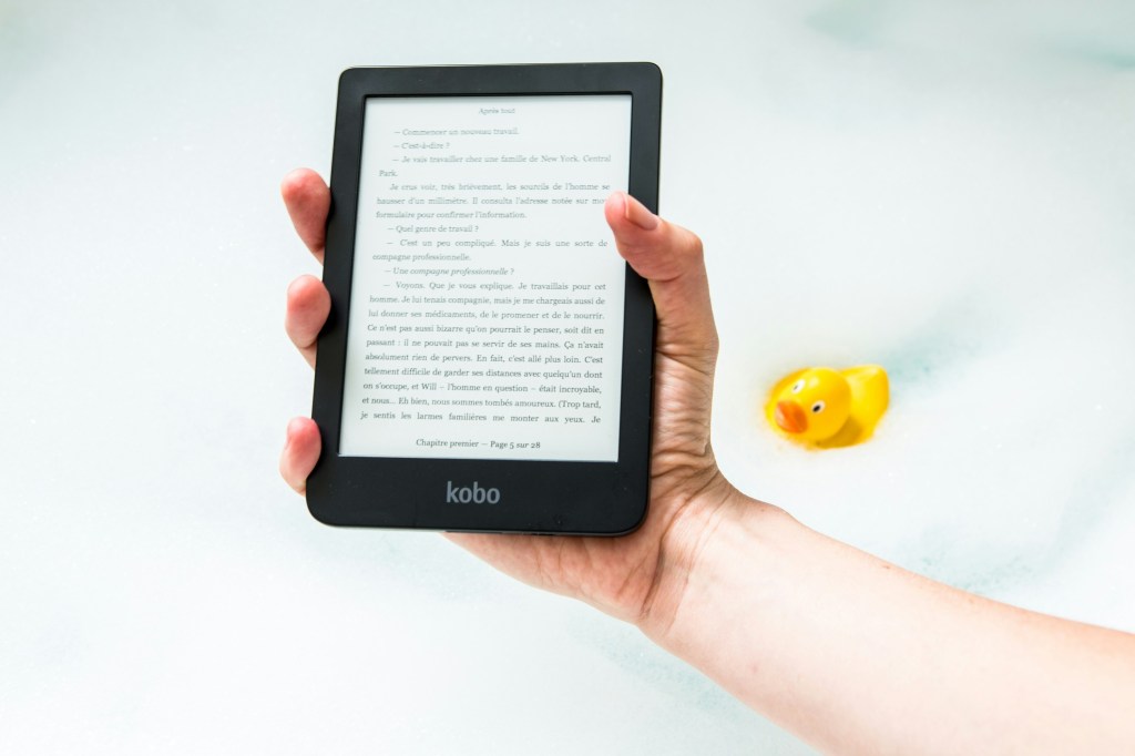 Image of a black Kobo eReader in a person's hand.