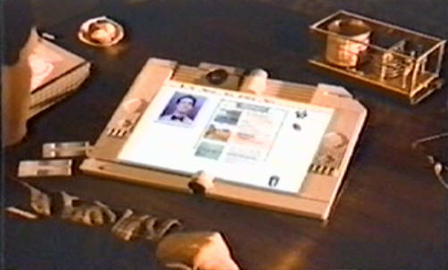 Image of Apple's Knowledge Navigator concept computer, a desktop tablet with AI voice assistant and multimedia capabilities.